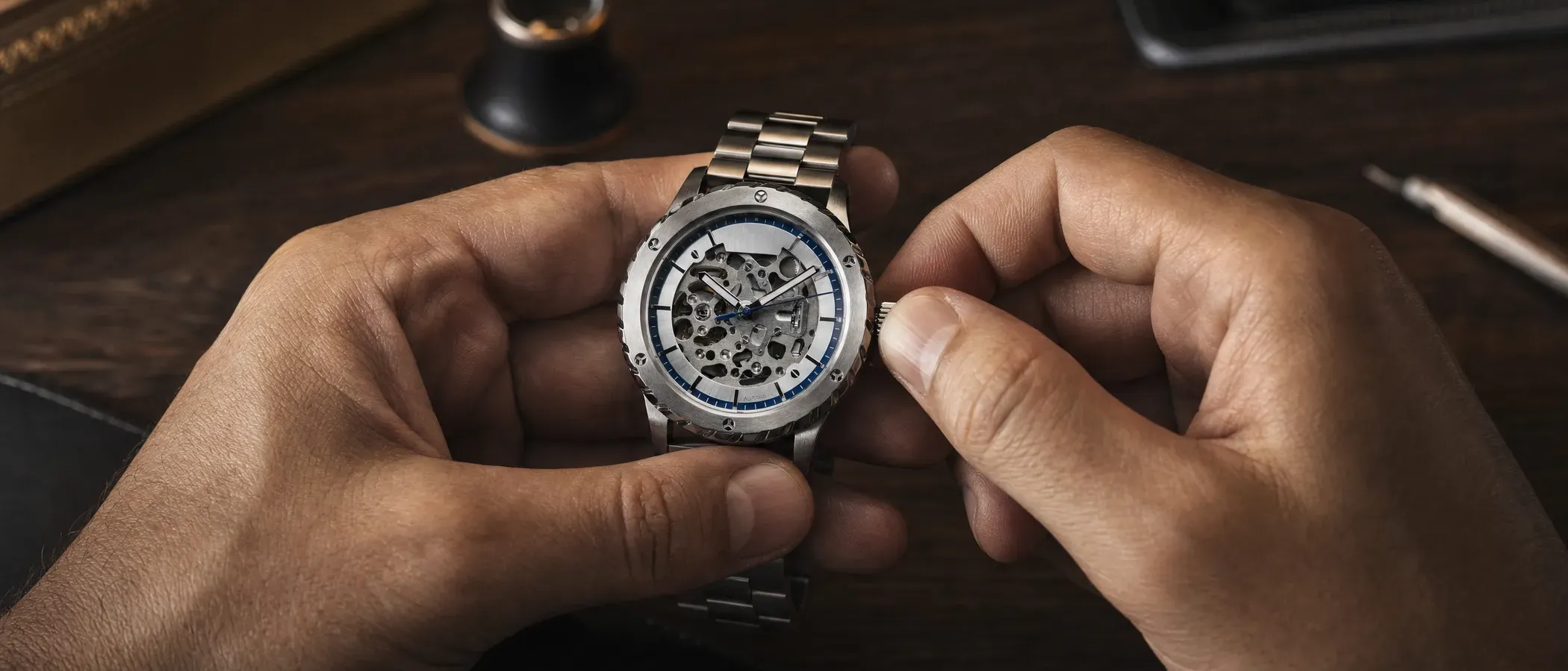 Close-up of a skeletonized automatic watch movement with the crown drawn out