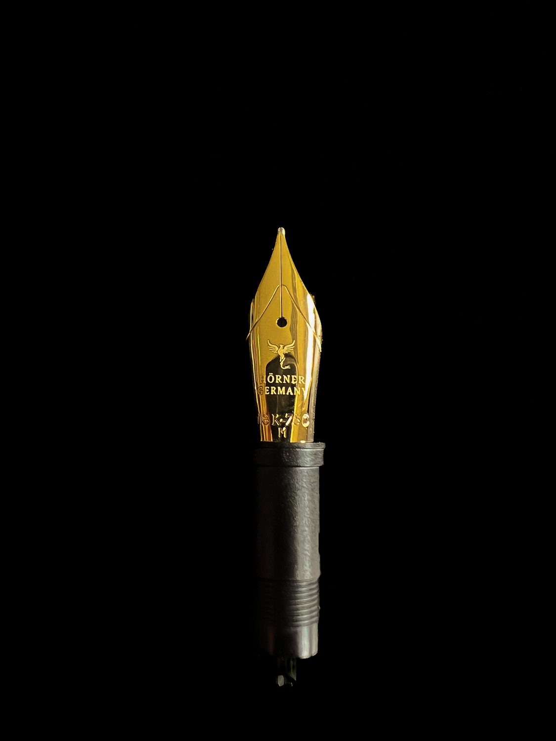 A solid 18k gold Hörner JoWo nib, size 6, on black